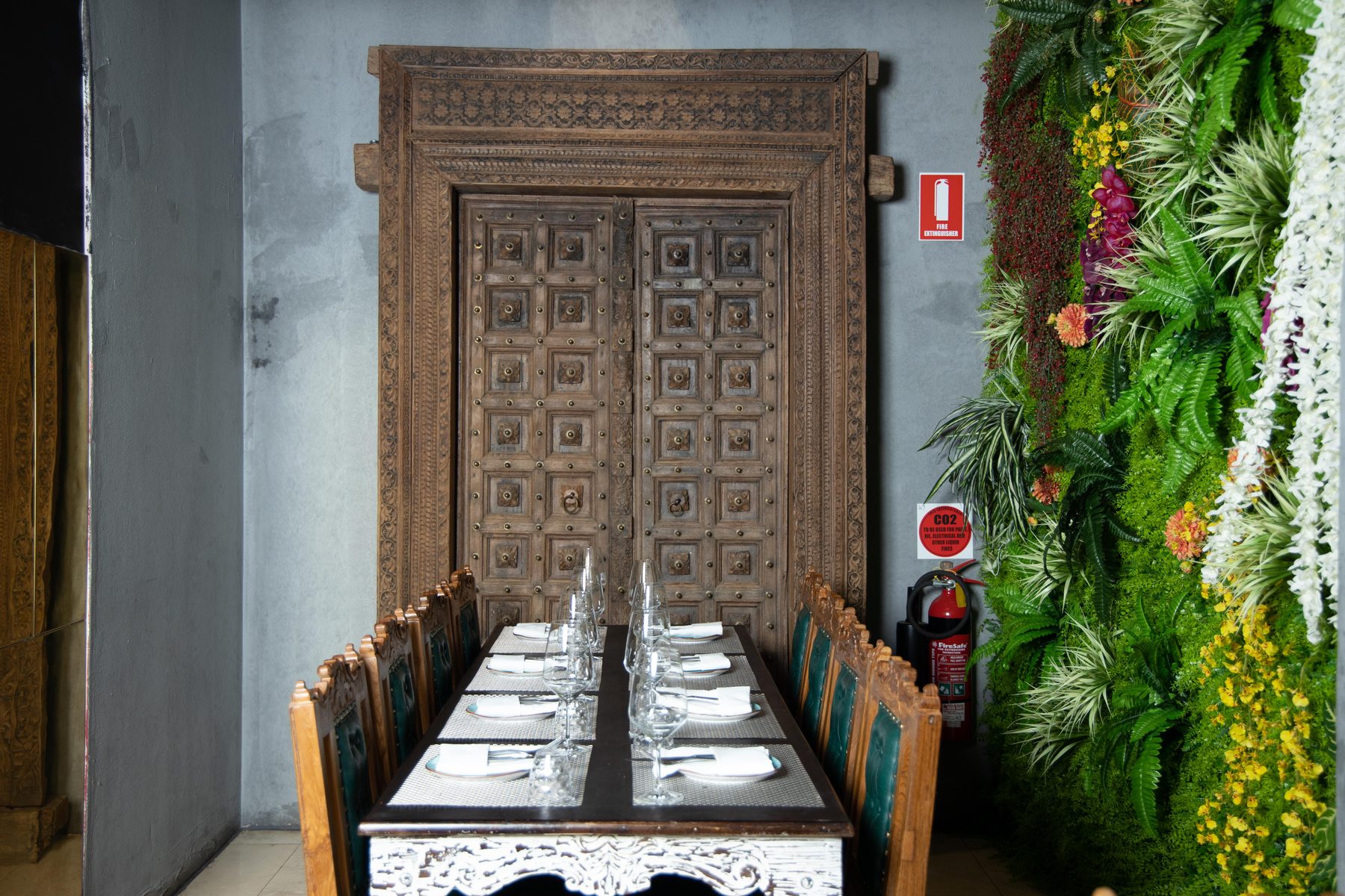 Private dining nook with carved door